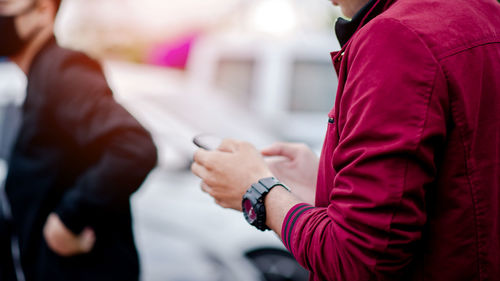 Midsection of man using phone