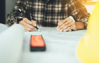 Close-up of man working on table