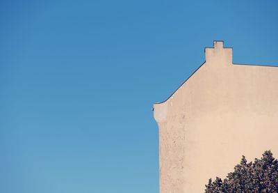 Low angle view of building against clear blue sky