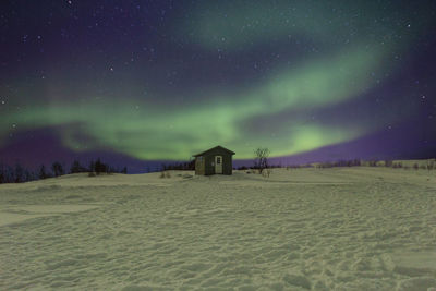 Scenic view of beach against sky at night nothern  lights