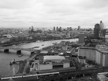 High angle view of river amidst buildings in city against sky