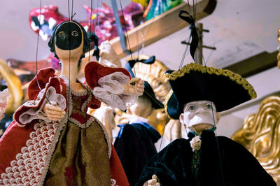 Low angle view of puppets hanging in store