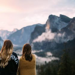 Rear view of friends against mountains