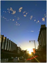 Buildings in city at sunset