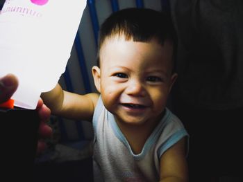 Portrait of cute happy baby boy playing at home