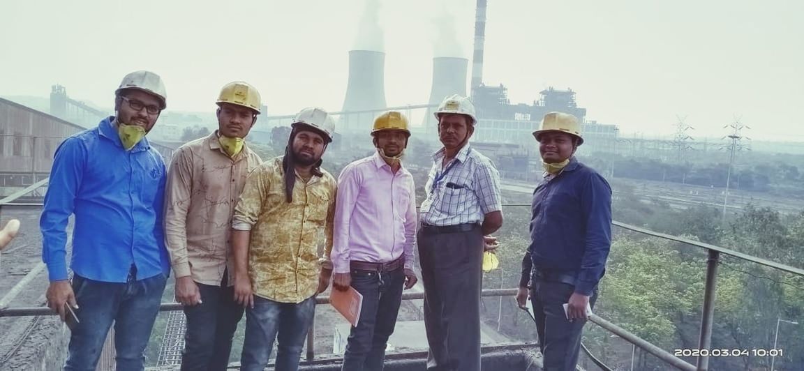 group of people, men, adult, architecture, occupation, standing, person, cooperation, day, togetherness, business, teamwork, industry, mature adult, women, smiling, young adult, coworker, nature, medium group of people, built structure, factory, engineering, group, clothing, looking at camera, sky, full length, headwear, building exterior, female, outdoors, communication, hat, helmet, portrait, businessman, front view