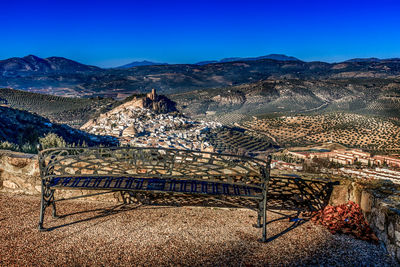 Aerial view of mountain range against blue sky