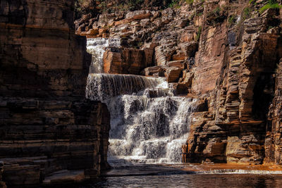 View of waterfall along rocks