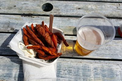 High angle view of fried sweet potatoes in beer on table