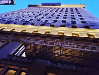 Low angle view of modern building against blue sky