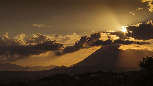 Scenic view of silhouette mountains against sky during sunset