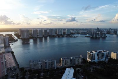 High angle view of buildings by sea against sky