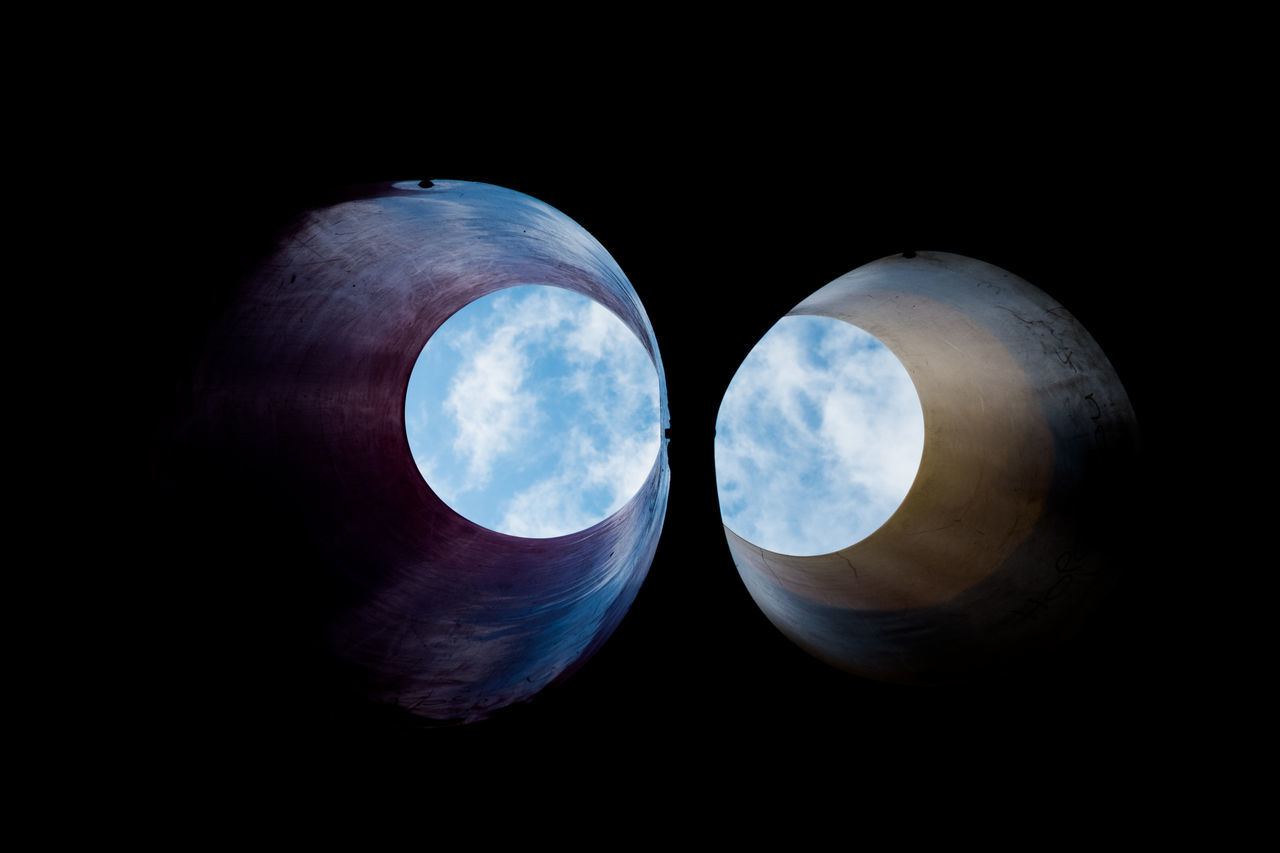 LOW ANGLE VIEW OF FULL MOON AGAINST BLACK BACKGROUND