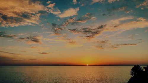 Scenic view of sea against sky at sunset