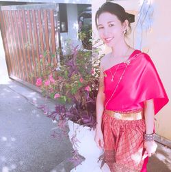 Portrait of a smiling young woman standing outdoors