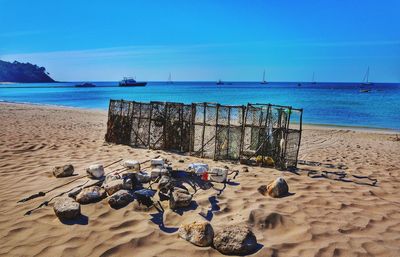 Rocks against crab pots on sandy beach