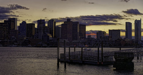 Buildings in city against sky during sunset