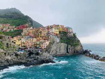 Scenic view of sea and buildings against sky