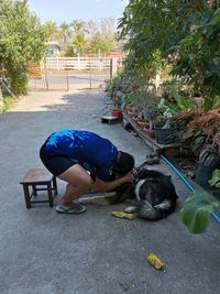 Man and woman with dog on plants