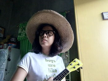 Portrait of young woman wearing hat