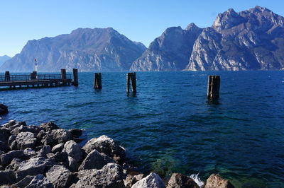 Scenic view of rocks in mountains against clear blue sky