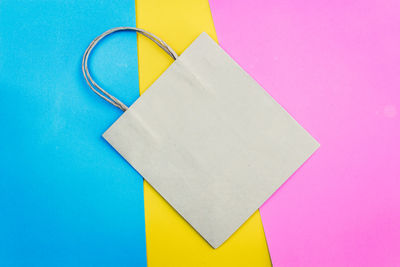 High angle view of paper bag on colorful table