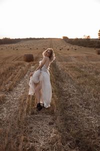 Rear view of woman standing on field