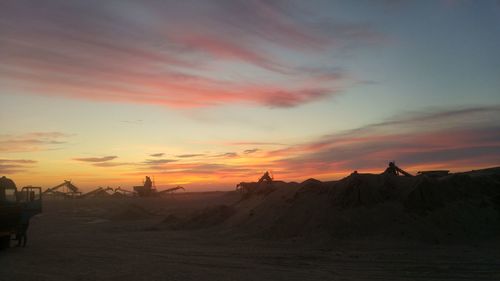 Silhouette of desert against sky during sunset