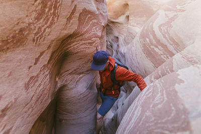 High angle view of hiker canyoneering amidst narrow canyons
