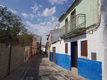 Empty alley amidst buildings in city