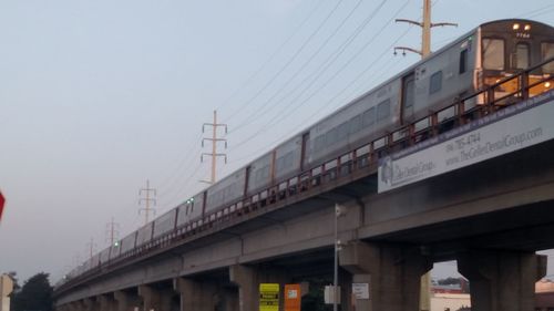 Low angle view of train on bridge against sky