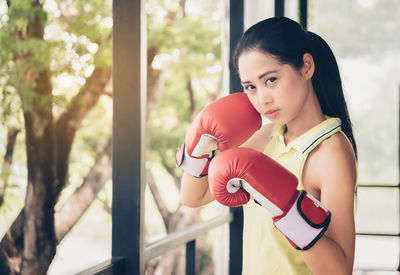 Portrait of young woman with boxing gloves