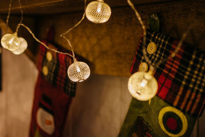 Low angle view of illuminated lighting equipment hanging on ceiling