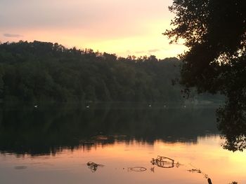 Scenic view of lake against sky at sunset