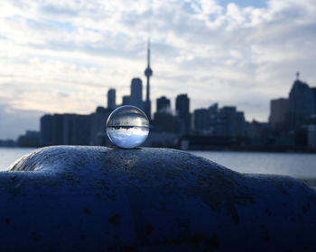 Close-up of crystal ball with buildings in background