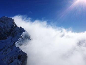 Low angle view of snowcapped mountains against sky