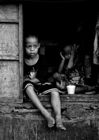 Siblings sitting on floor