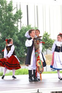 People in traditional clothing standing outdoors