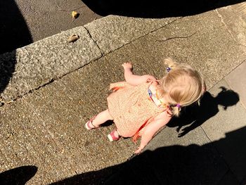 High angle view of girl with cat on shadow