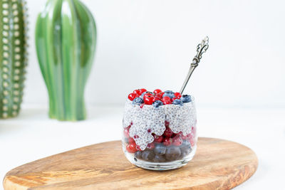 Chia seed pudding with blueberries and red currant berries in a glass