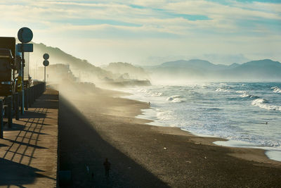 Scenic view of beach against sky during sunrise