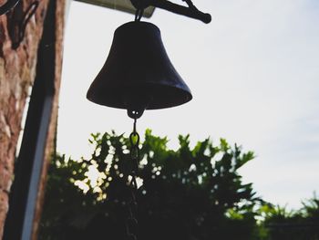 Low angle view of hanging light against sky