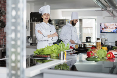 Portrait of chefs preparing food in kitchen