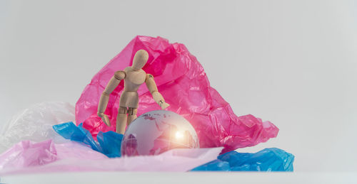 Close-up of multi colored balloons against white background