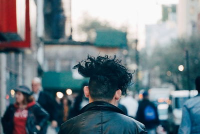 Rear view of man on street in city