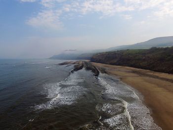 Scenic view of beach against sky