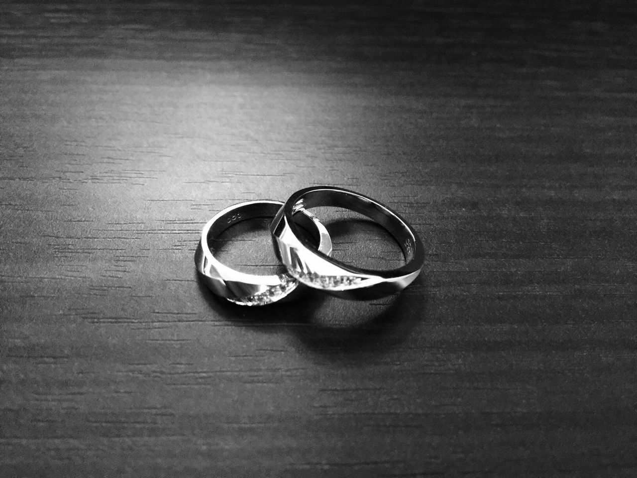 still life, indoors, table, high angle view, close-up, single object, wood - material, metal, two objects, no people, circle, man made object, drink, wooden, coin, personal accessory, metallic, number, directly above, shadow