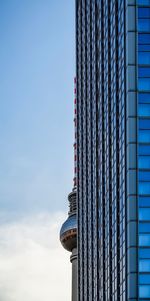 Low angle view of modern building and fernsehturm against sky