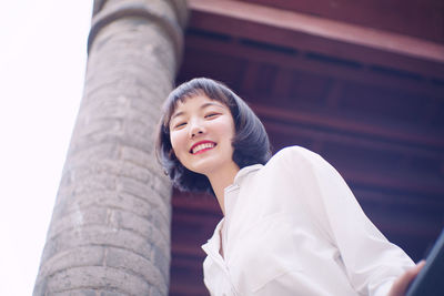 Portrait of smiling woman standing outdoors