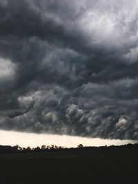 Scenic view of dramatic sky over field